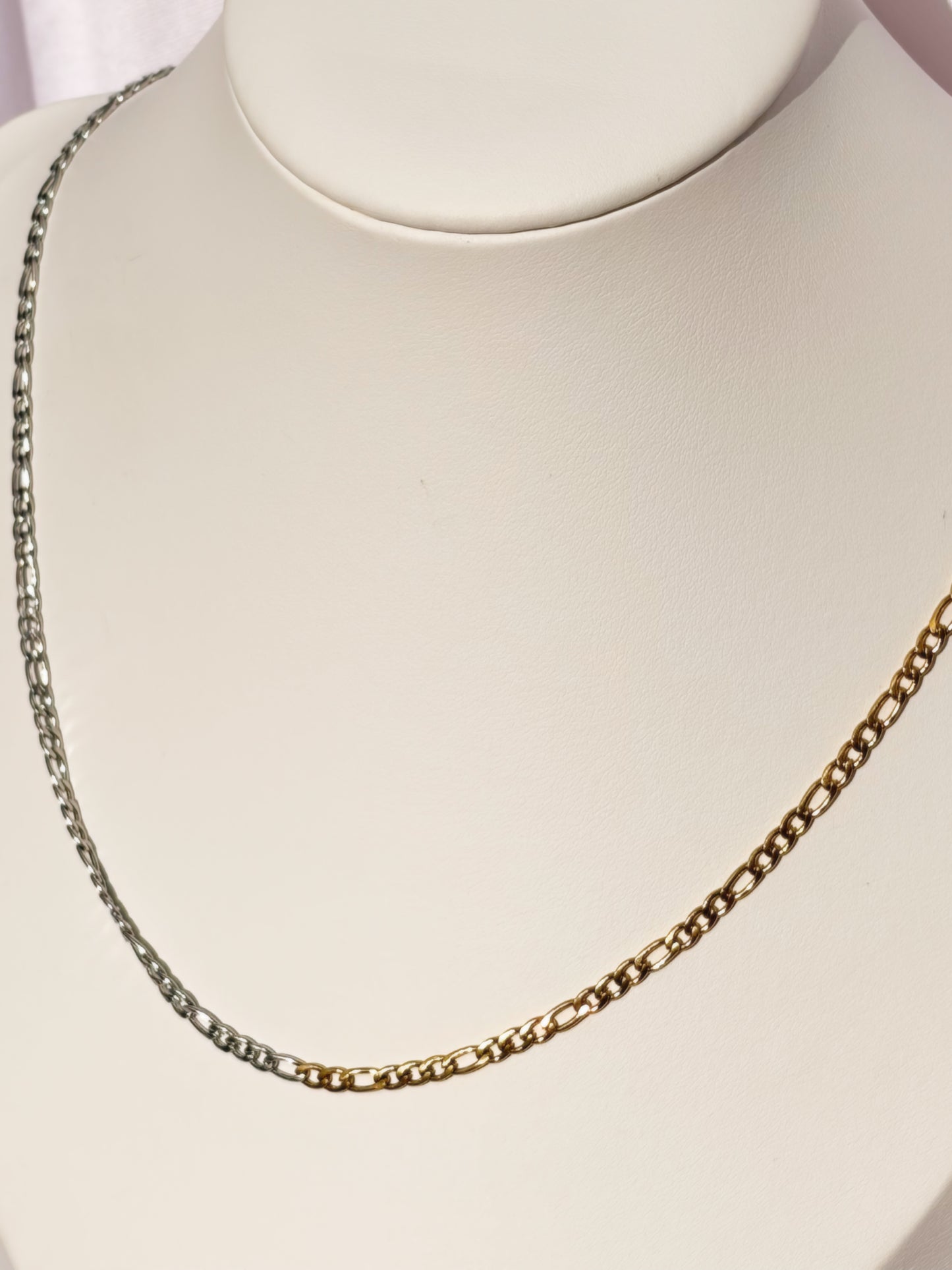 Figaro Gold and Silver Necklace on a bust on a white background.