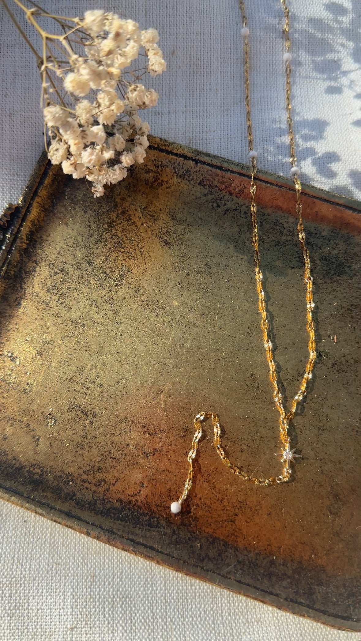 Gold Stainless Steel Faux Pearl chain necklace with a sunburst charm.