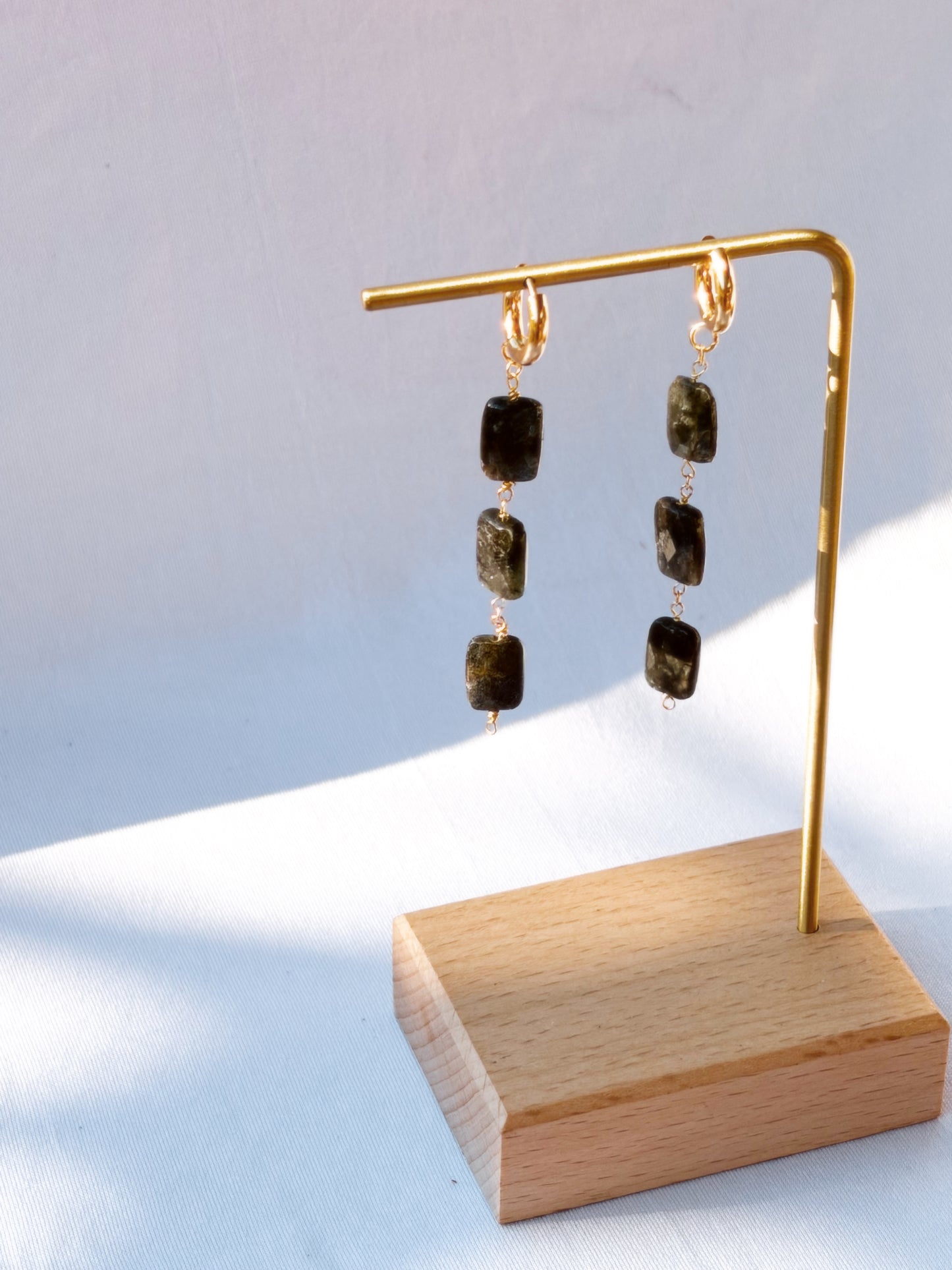 Stainless Steel Gold earrings with Blue Kyanite gemstones on a white background.