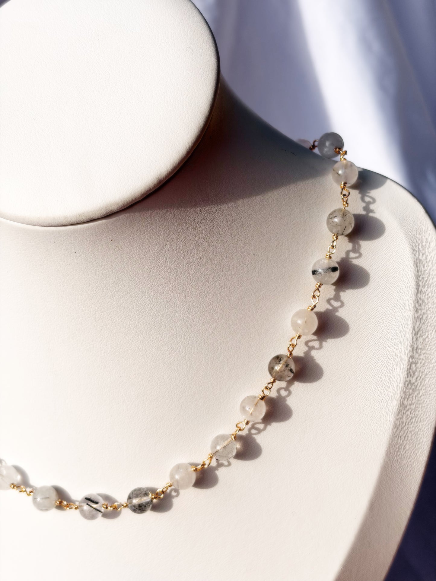 Close up of Wire Wrapped Black Rutilated Quartz Necklace Choker on Stainless Steel wire