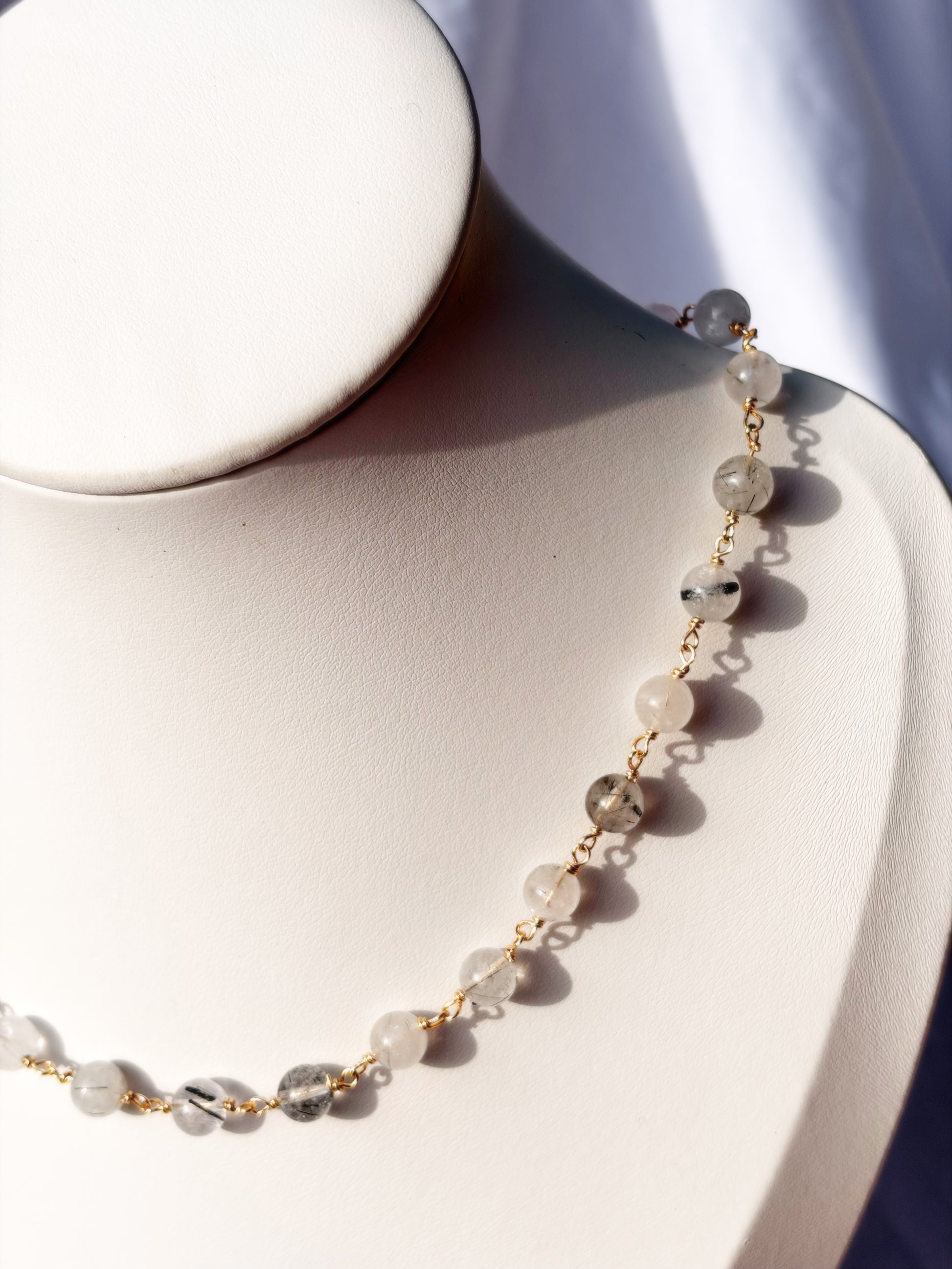Close up of Wire Wrapped Black Rutilated Quartz Necklace Choker on Stainless Steel wire