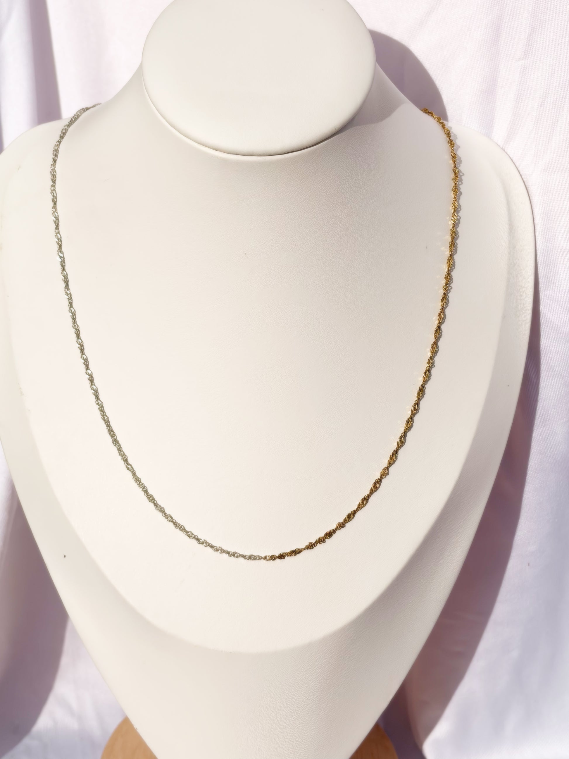 Figaro Gold and Silver Necklace on a bust on a white background.