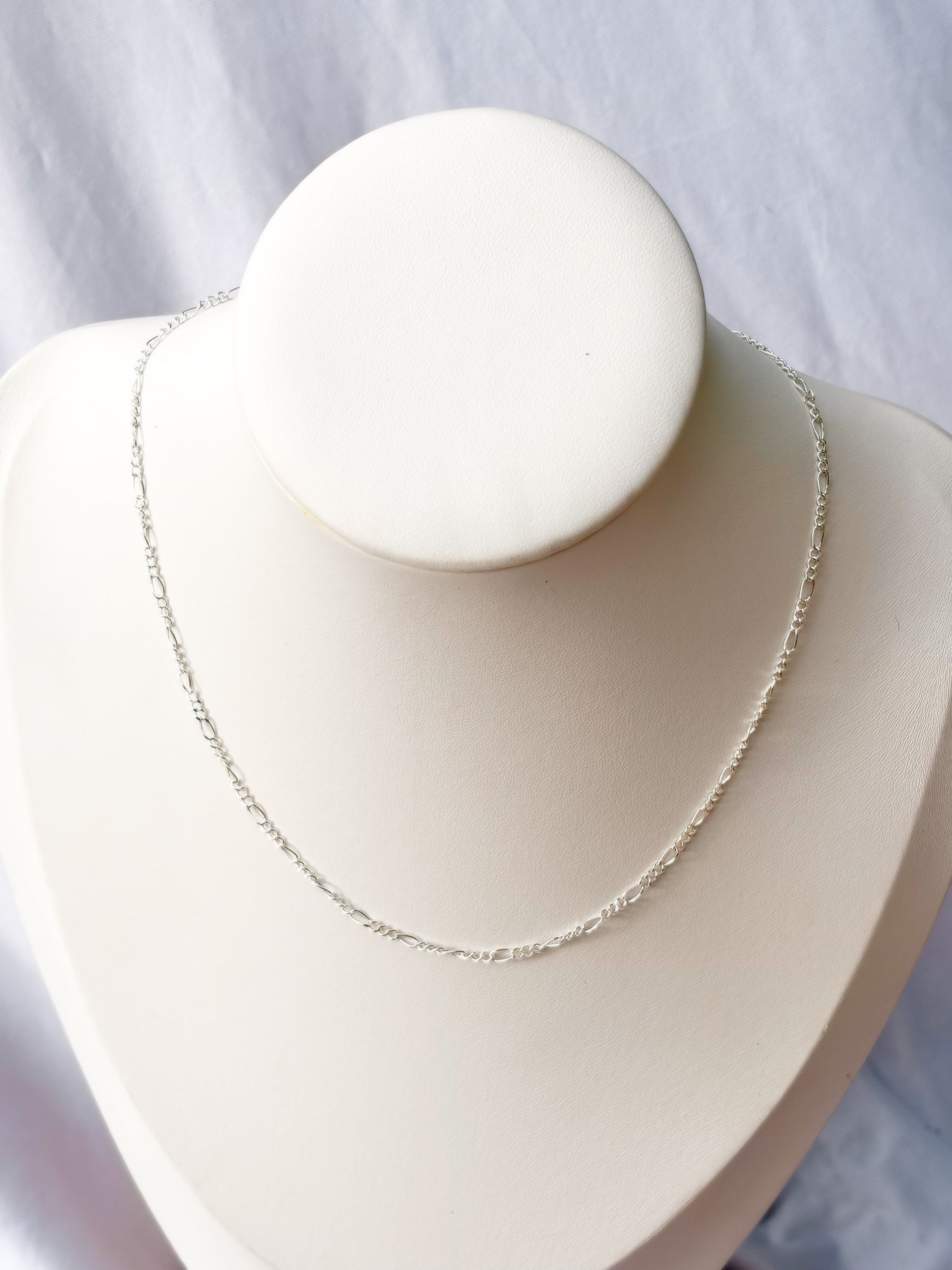 Figaro Stainless Steel Silver chain Necklace on a white mannequin bust and background.